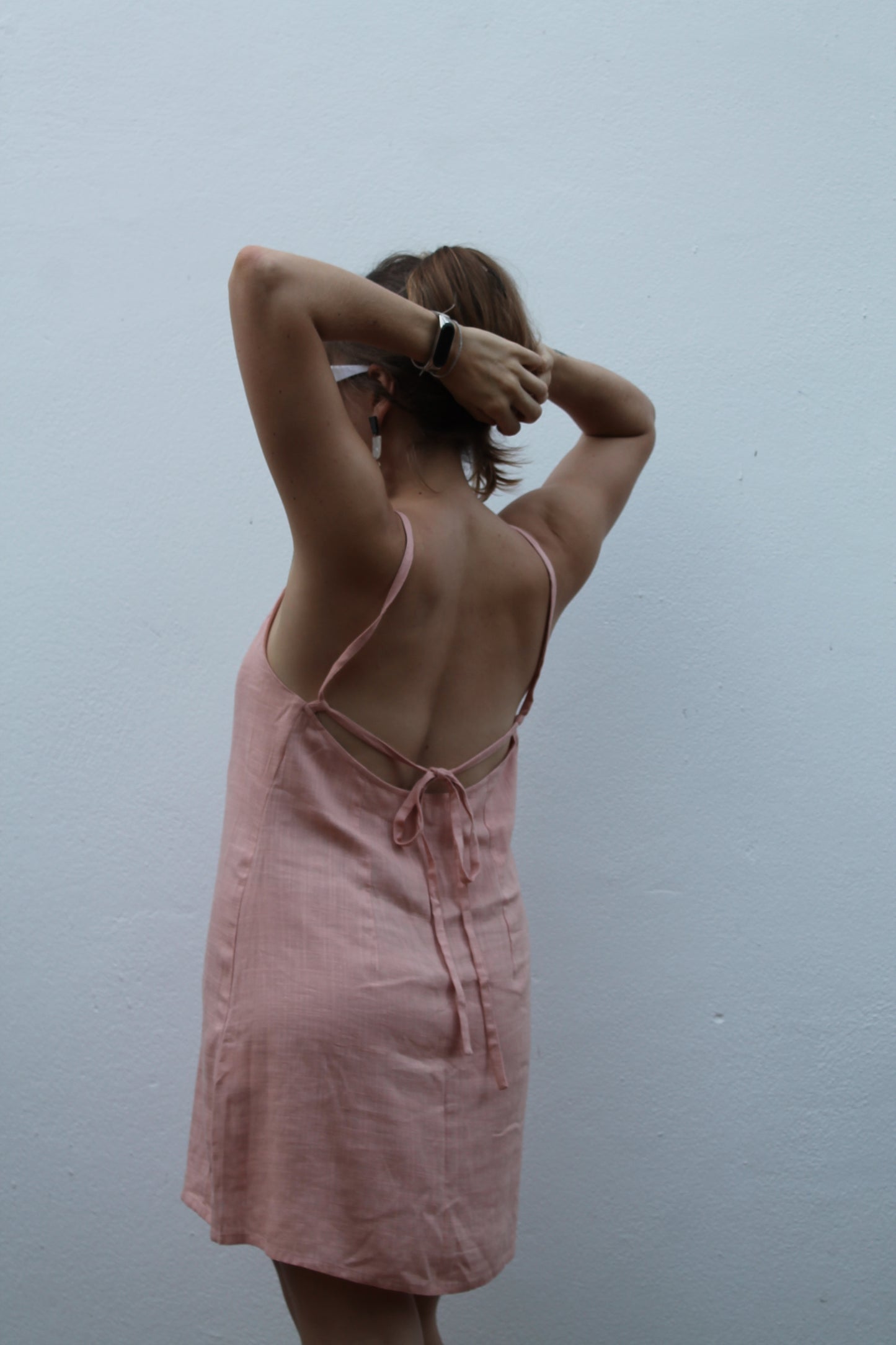 Pale pink backless linen dress.