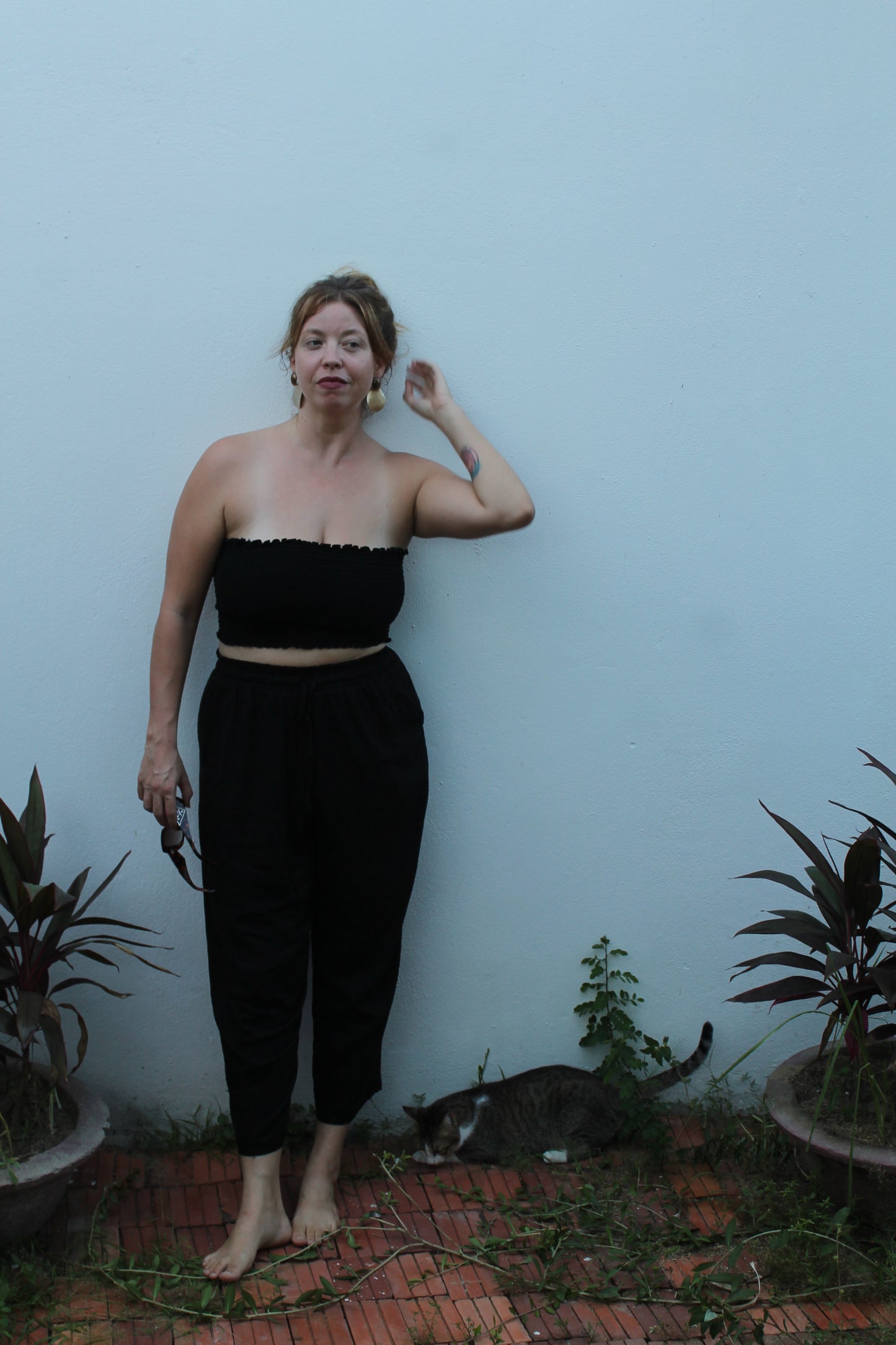 Person wearing black pants and a tube top.