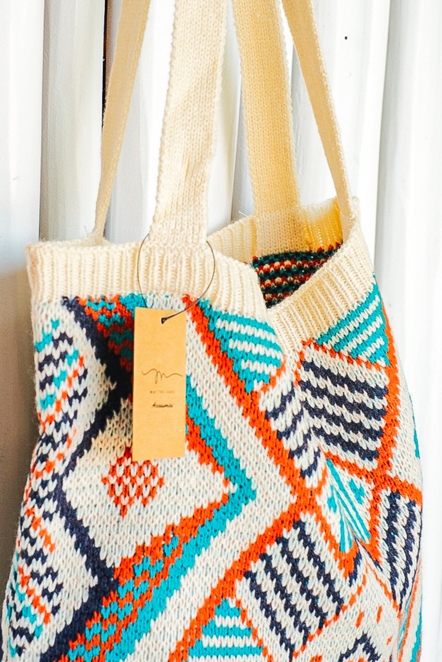 Orange, blue and cream colored geometric pattern purse.