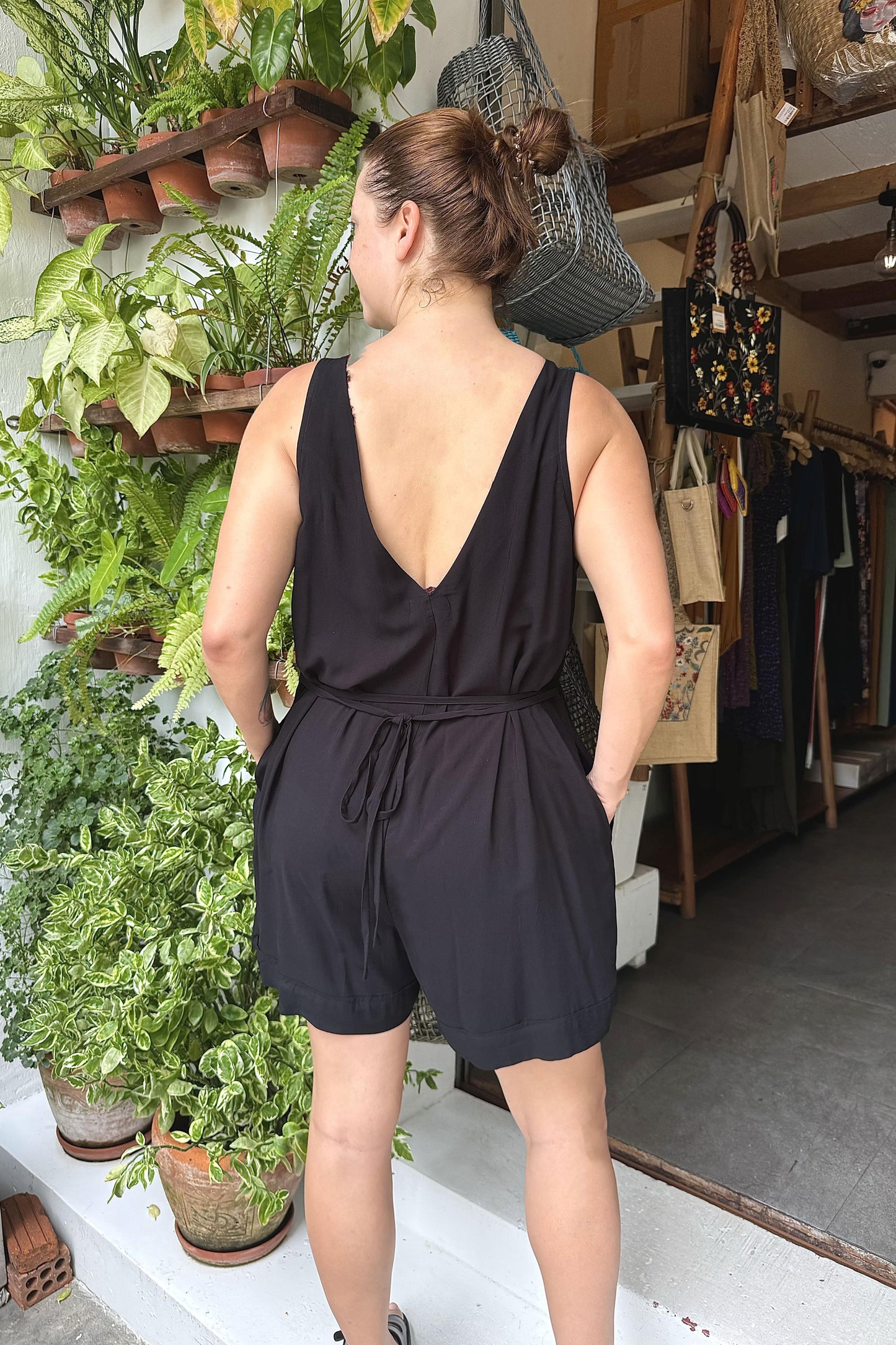 rear view of a woman wearing a black playsuit boho style