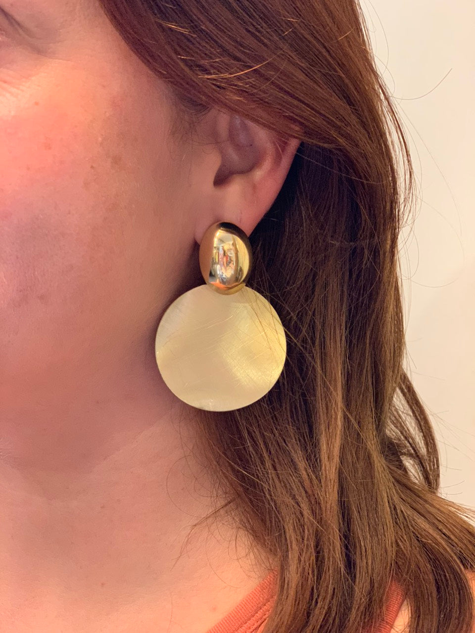 woman wearing boho style gold round earrings