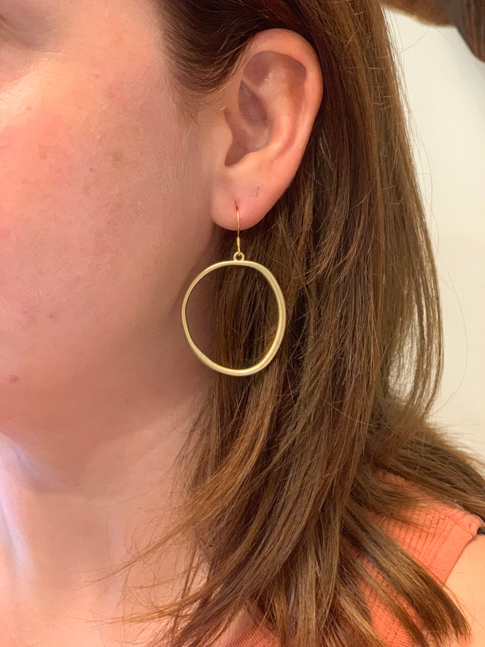 woman wearing boho style round loop gold earrings