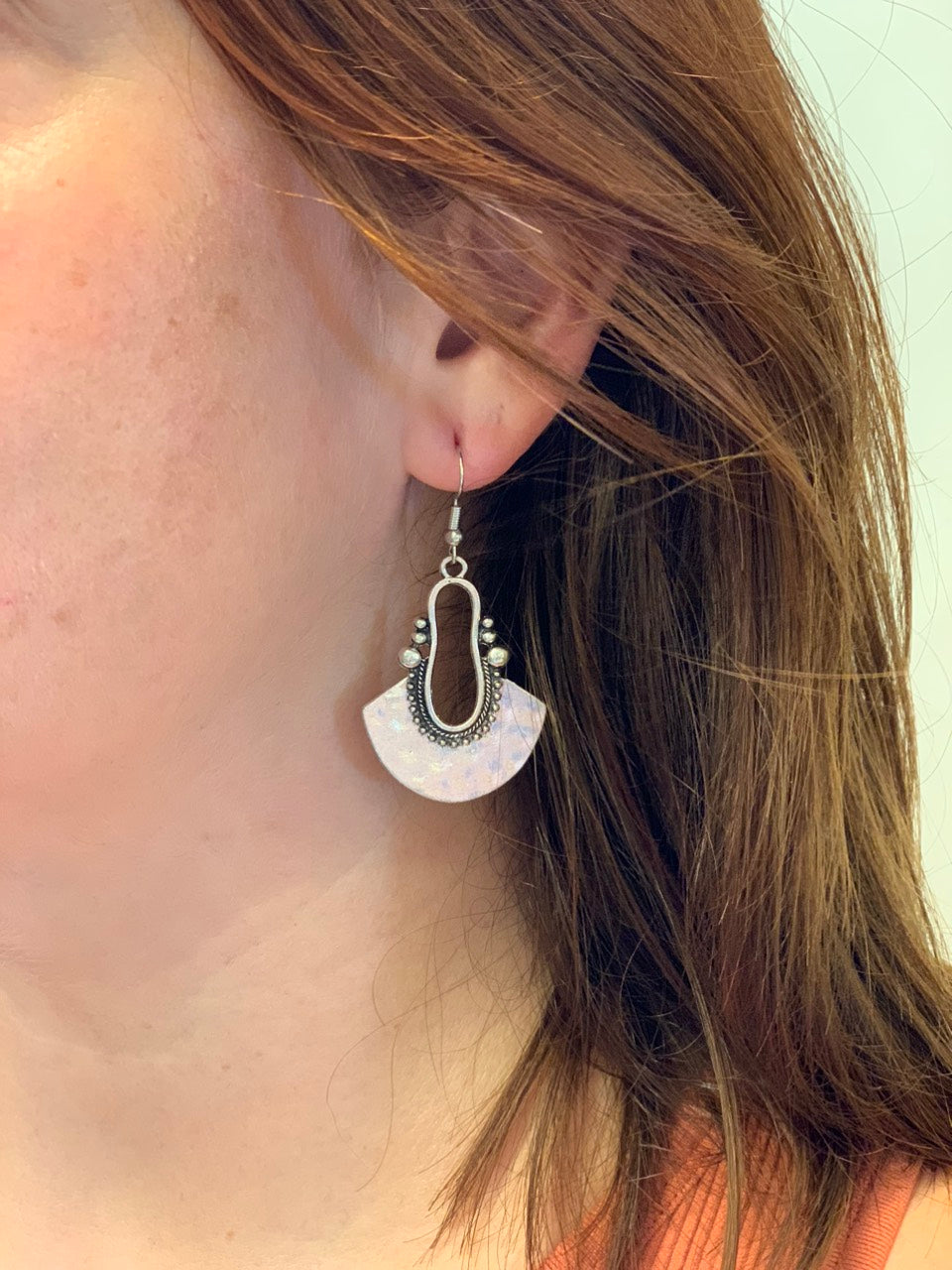 woman wearing boho style silver fanned earrings