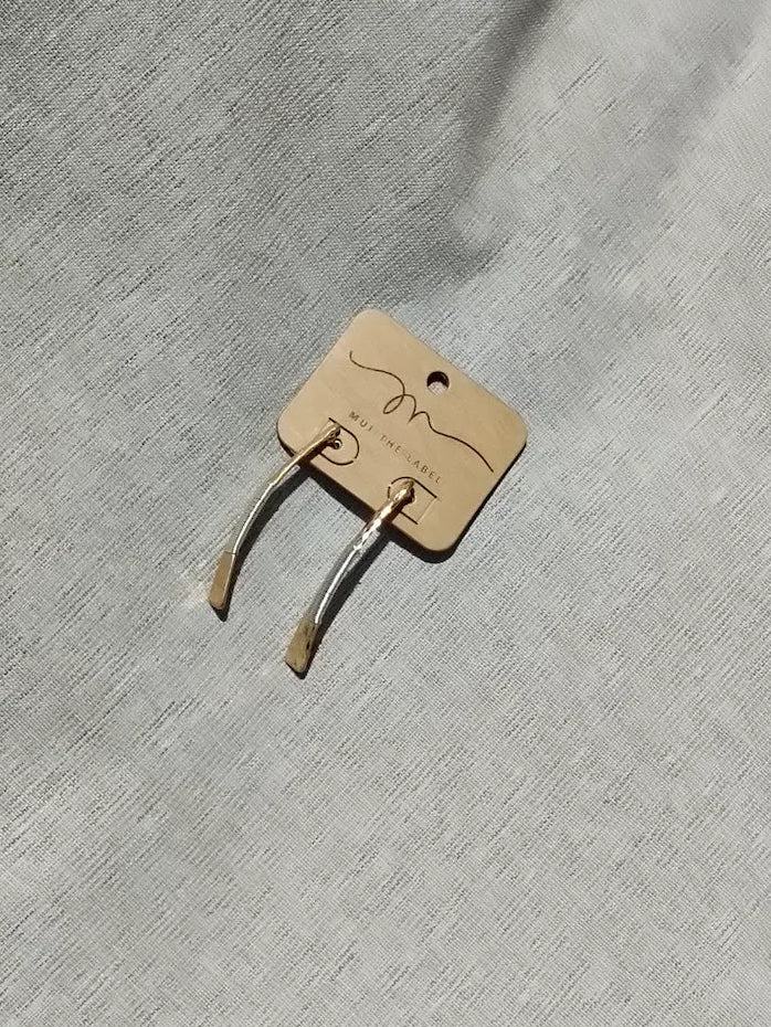 Gold metal clip on a gray fabric background