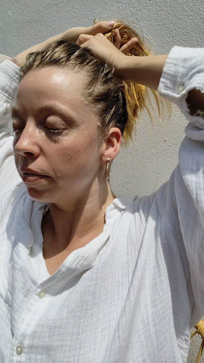 Woman wearing gold earrings. 