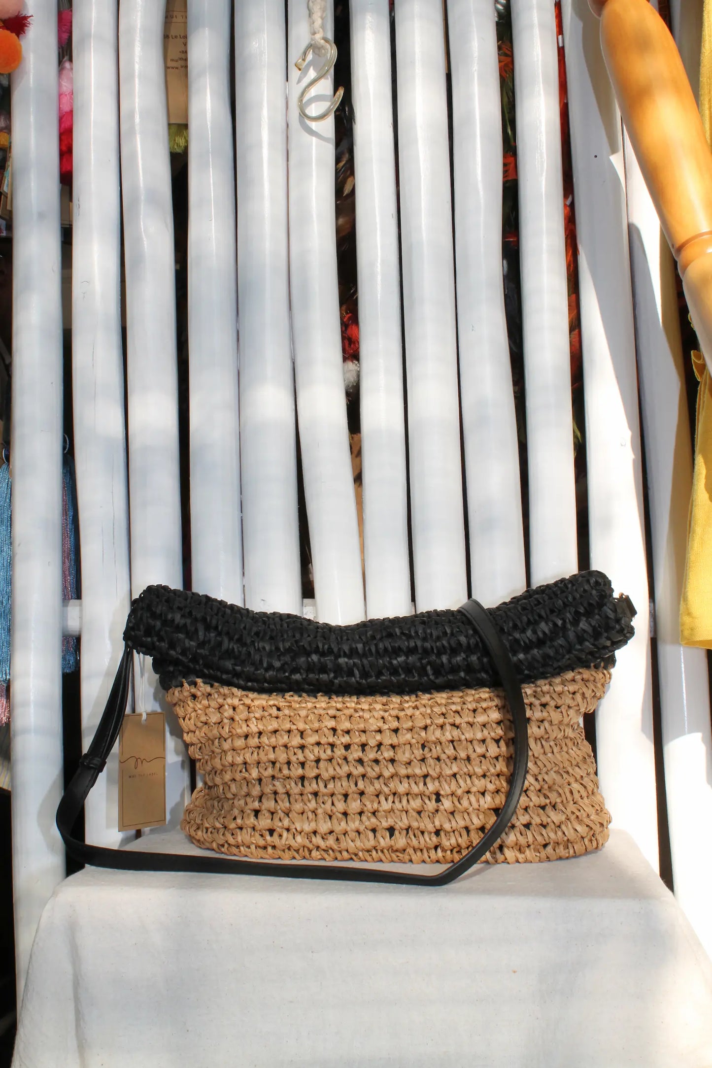 A woven bag with black and cream color.