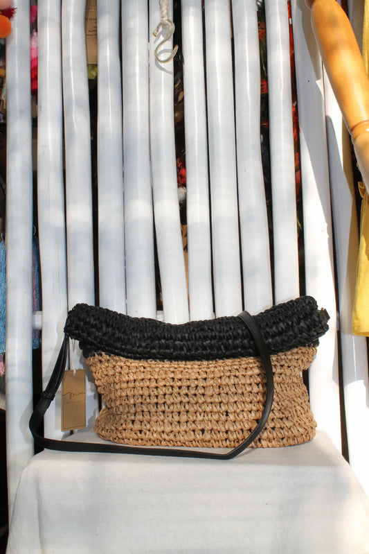 A woven bag with black and cream color.
