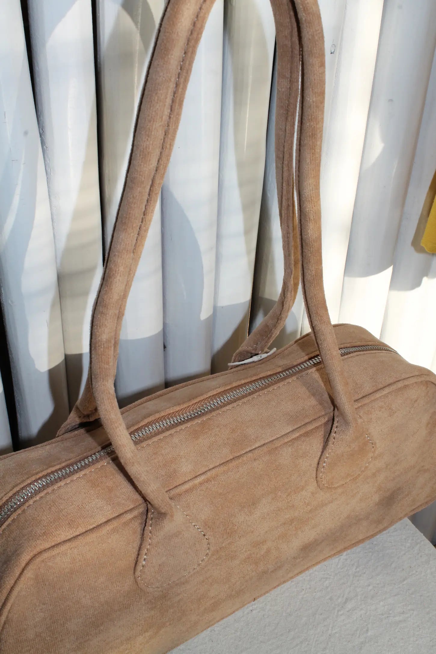 A brown faux suede bag. 