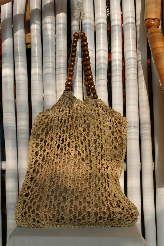 A large woven bag with beaded handles. 