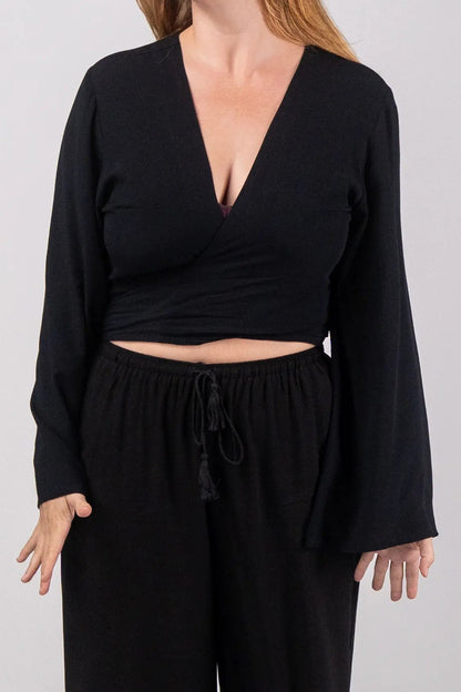 Woman wearing a black outfit on a plain background