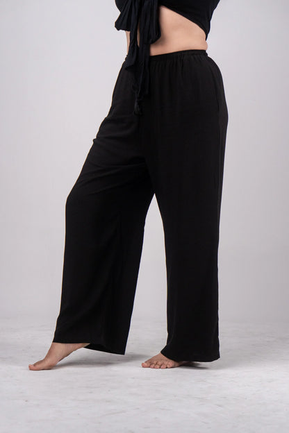 Black wide-leg pants worn by a person on a light gray background