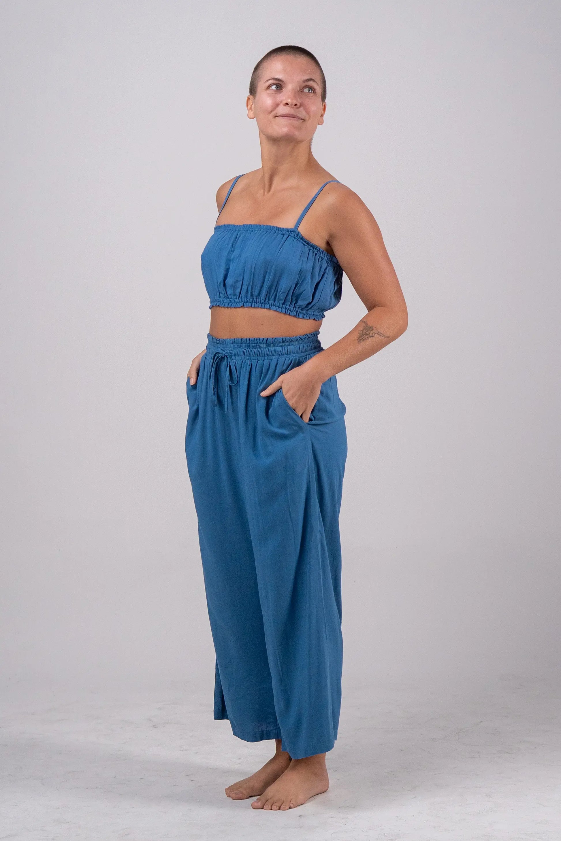 Woman wearing a blue outfit on a plain background