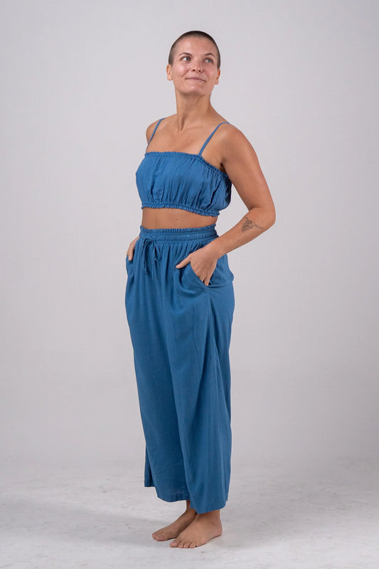 Woman wearing a blue outfit on a plain background