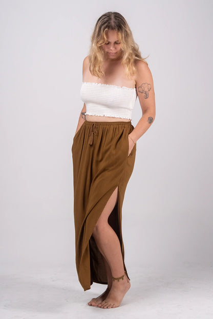 Woman wearing a white top and brown skirt on a white background