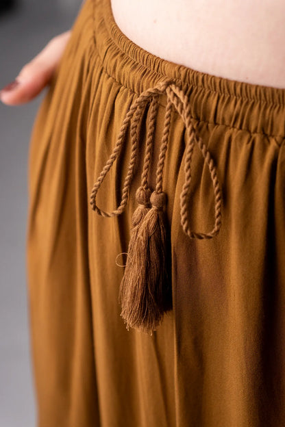 Brown skirt with tassels on a gray background
