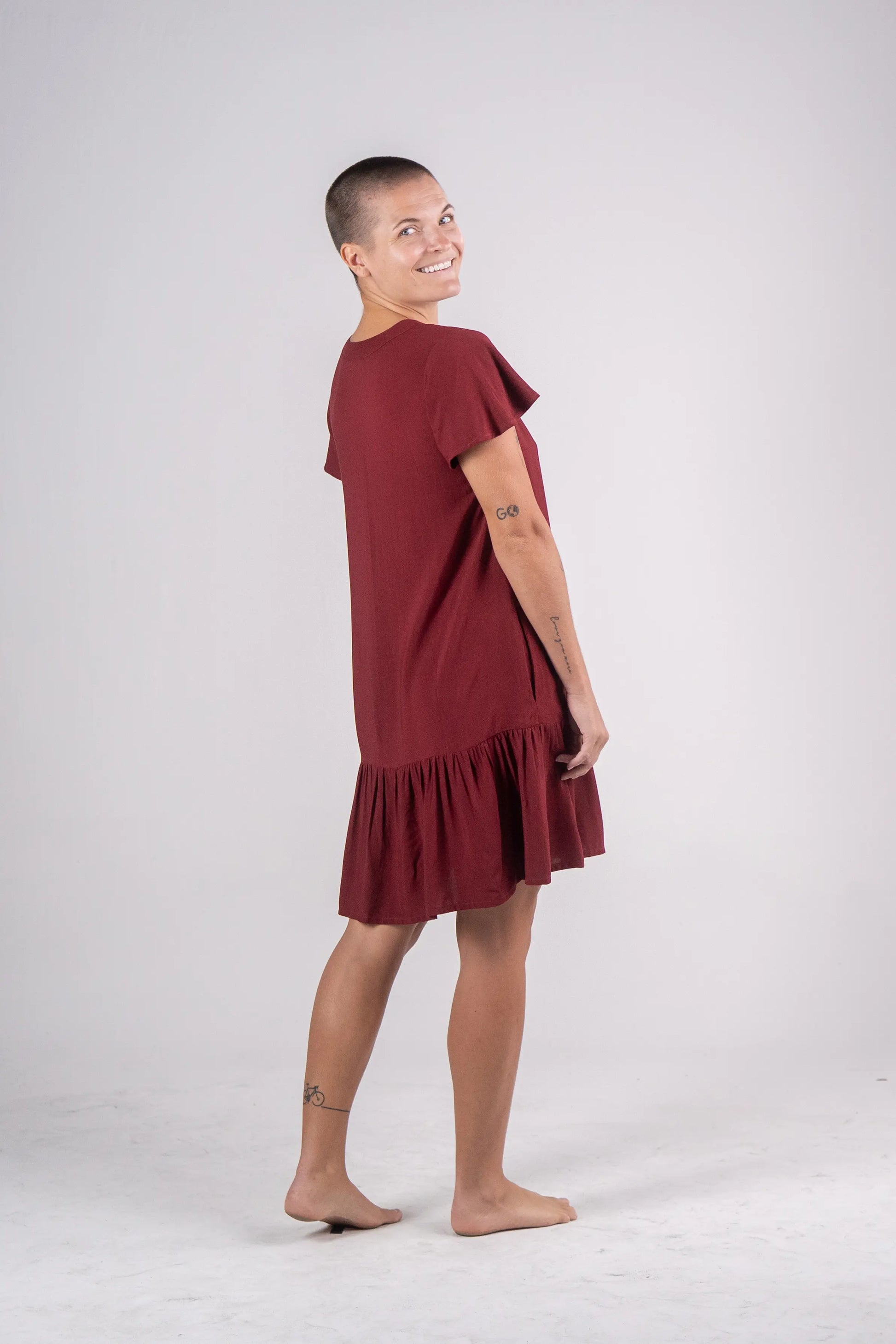 Woman wearing a burgundy dress on a white background