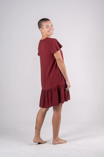 Woman wearing a burgundy dress on a white background
