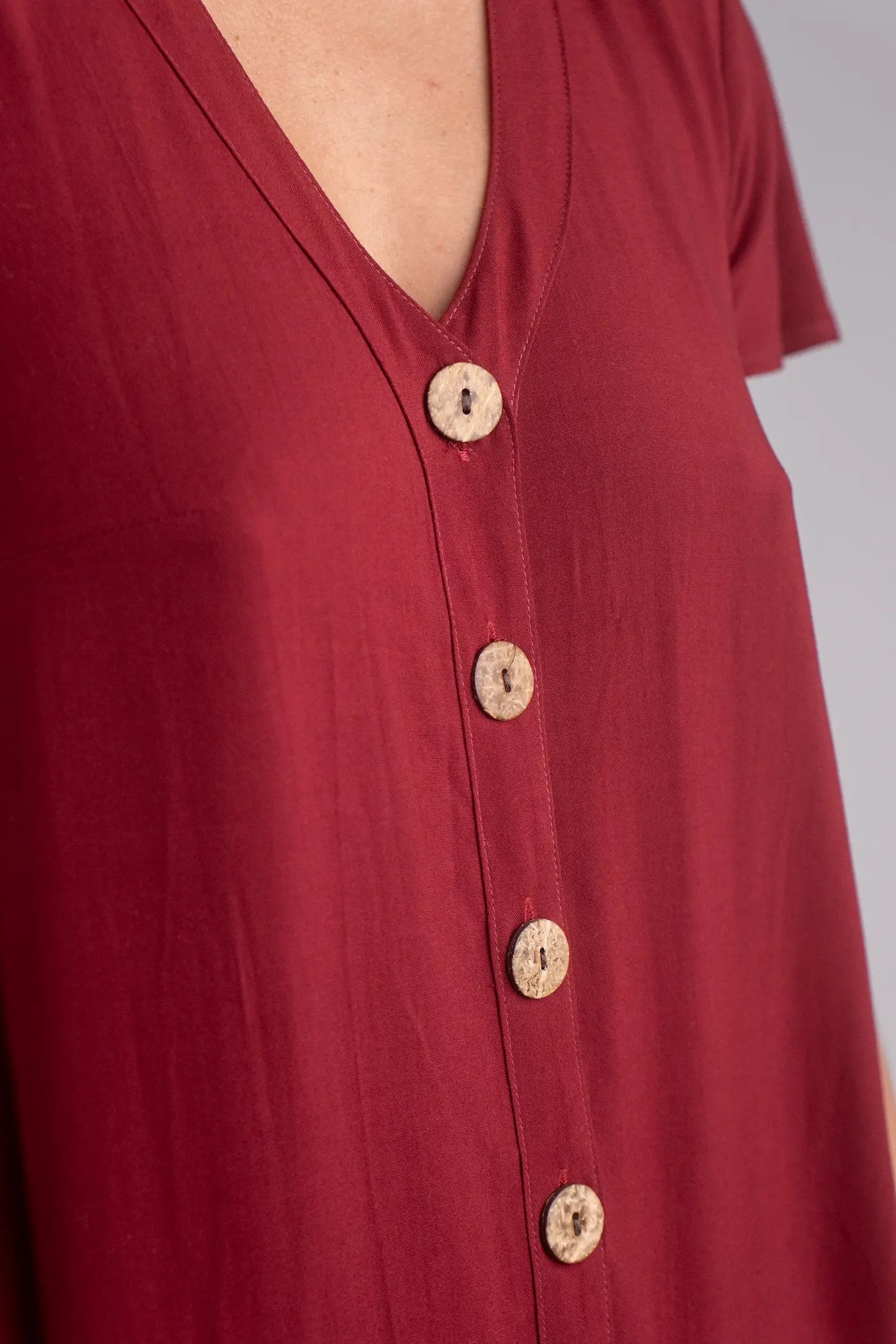 Red shirt with buttons on a plain background
