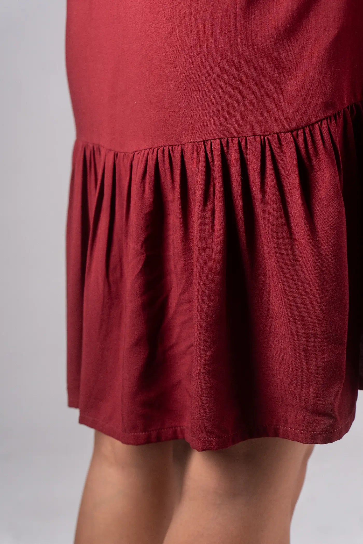 Red dress with a ruffled hem on a plain background