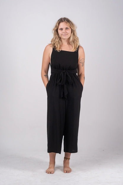 Woman wearing a black jumpsuit on a white background