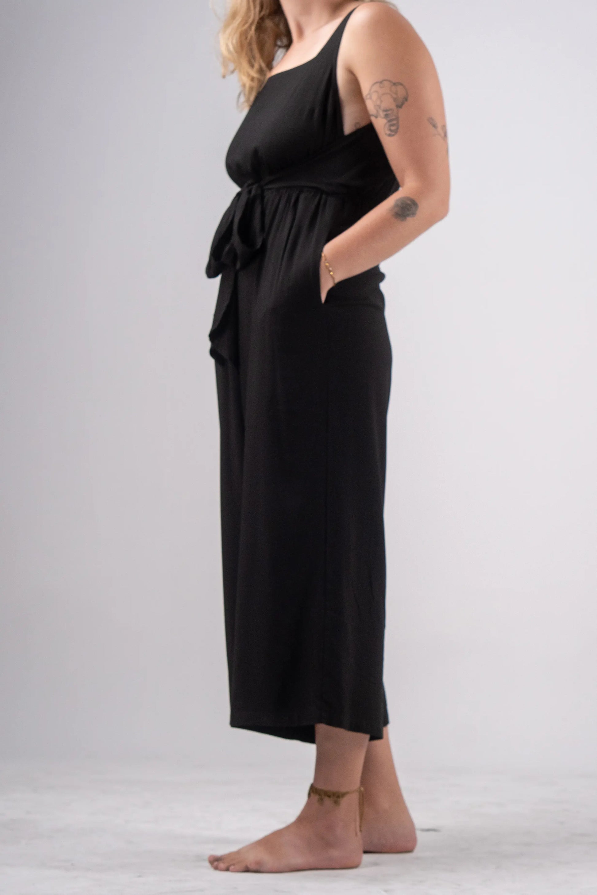 Person wearing a black dress with a white background