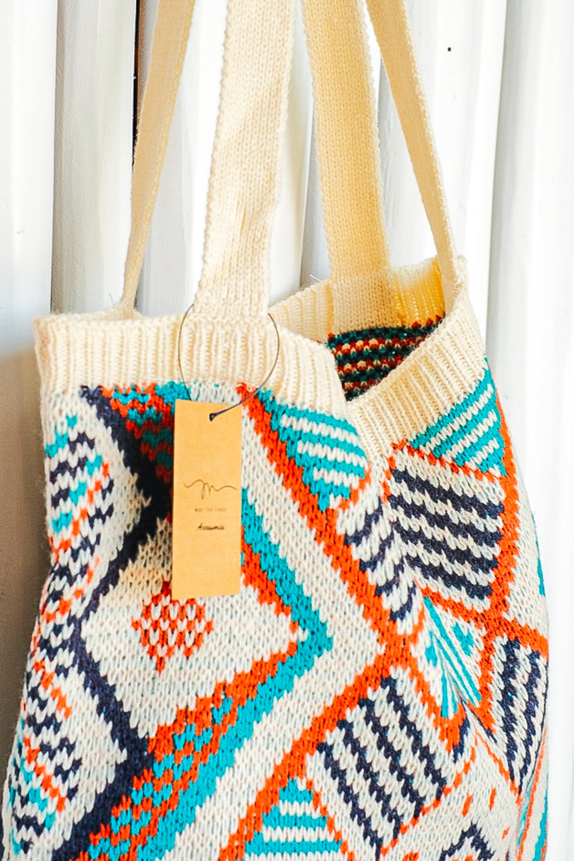 Orange, blue and cream colored geometric pattern purse.
