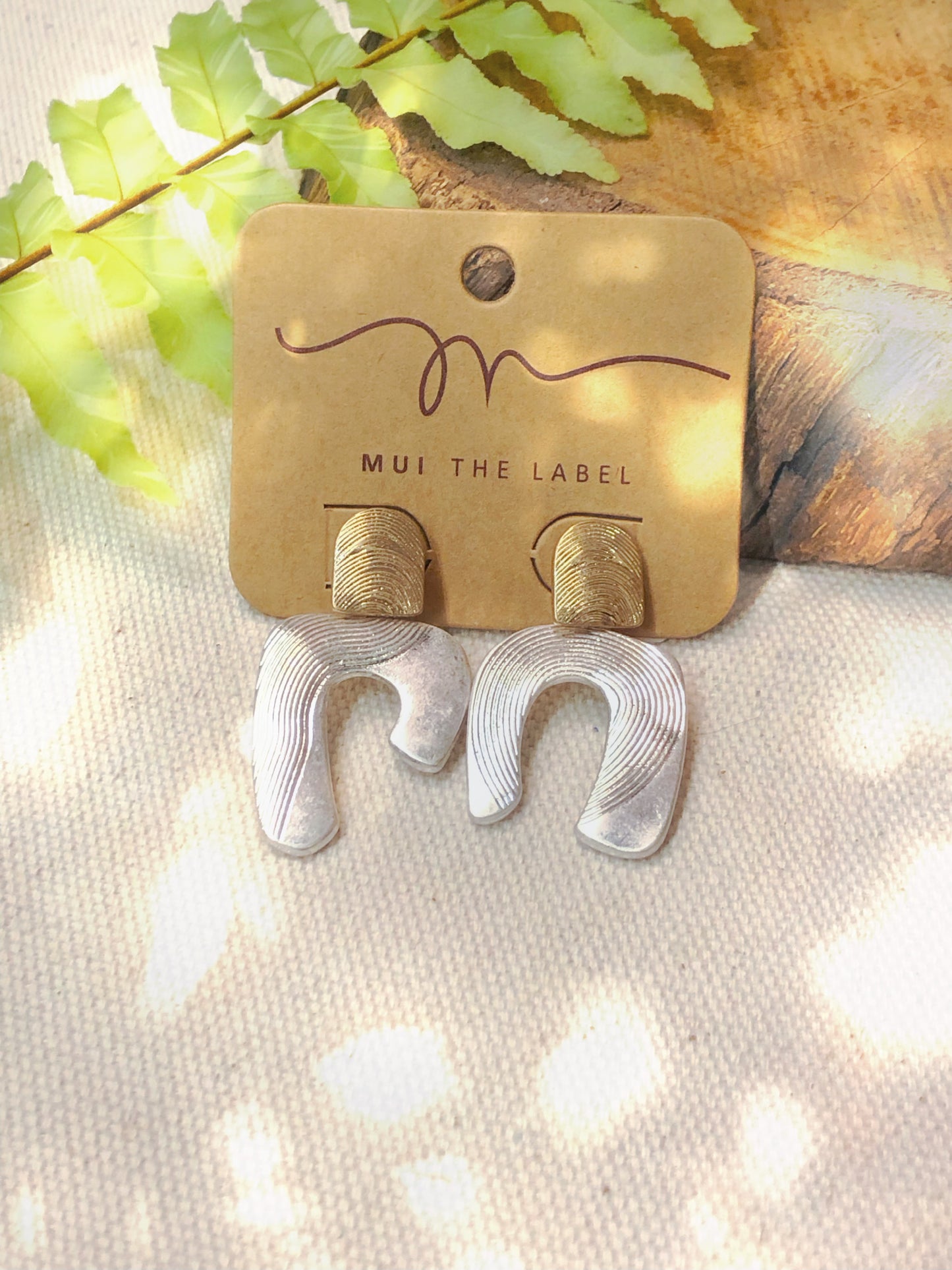 Silver horseshoe with gold detail earrings. 
