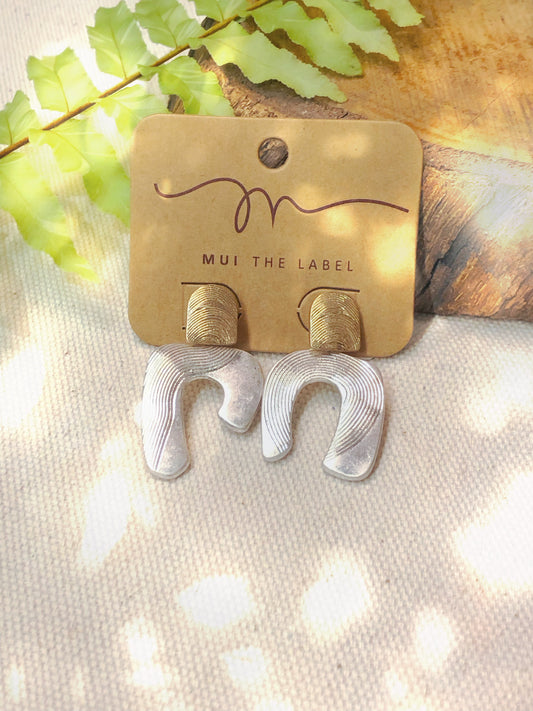 Silver horseshoe with gold detail earrings. 