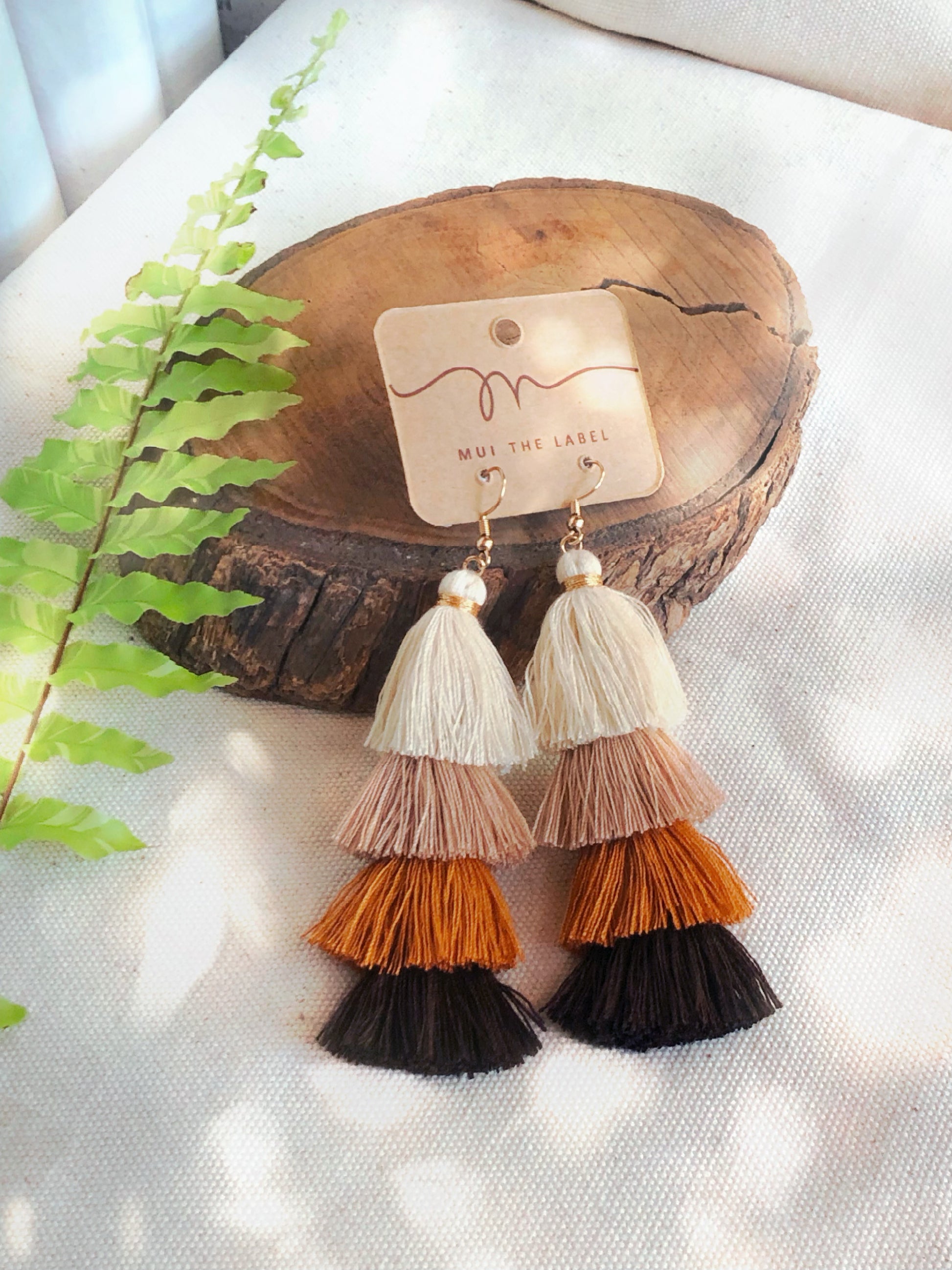 Brown and white tassel earrings. 