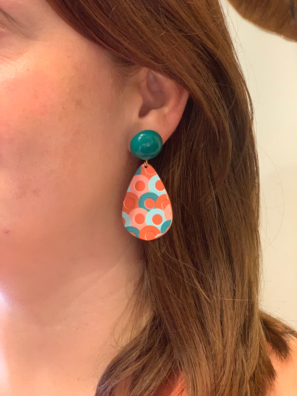 woman wearing boho style colorful circle pattern acrylic earrings