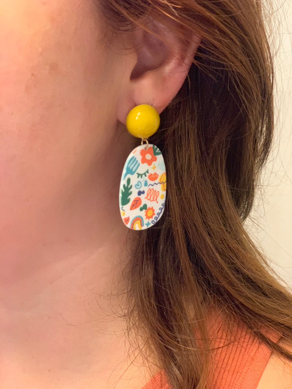 Earrings with colorful fun design and yellow detail. 