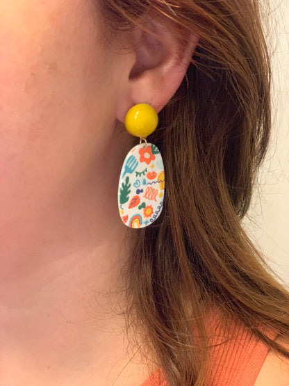 Earrings with colorful fun design and yellow detail. 