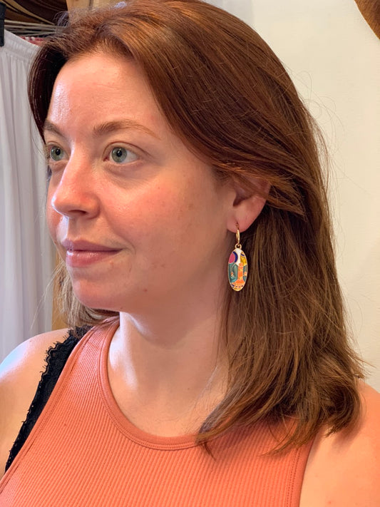 woman wearing boho style oval multicolor earrings
