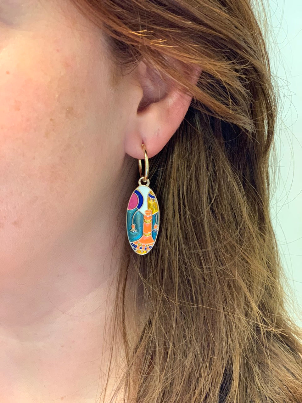 woman wearing oval multicolor earrings