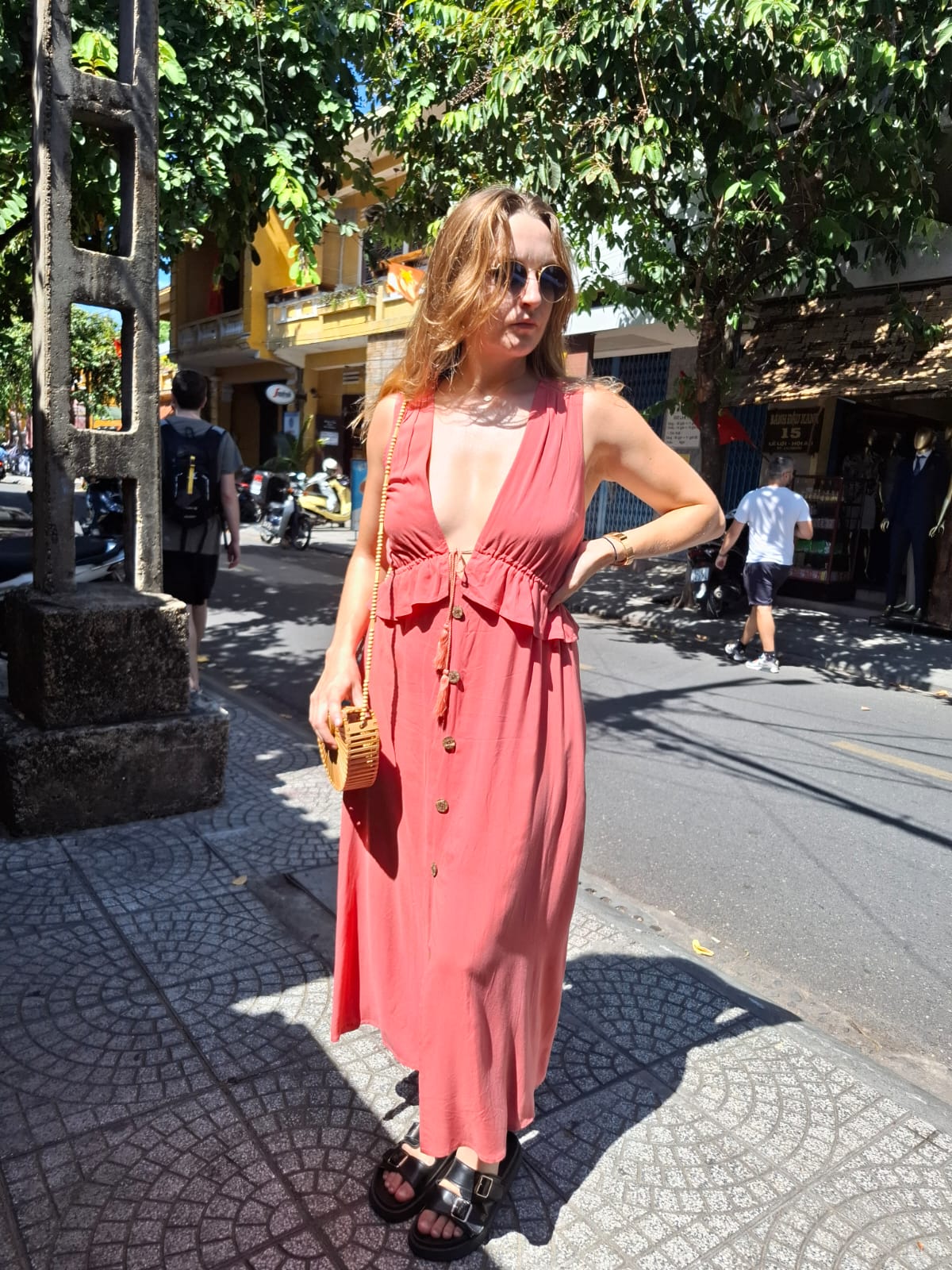 a woman in a boho  style coral dress