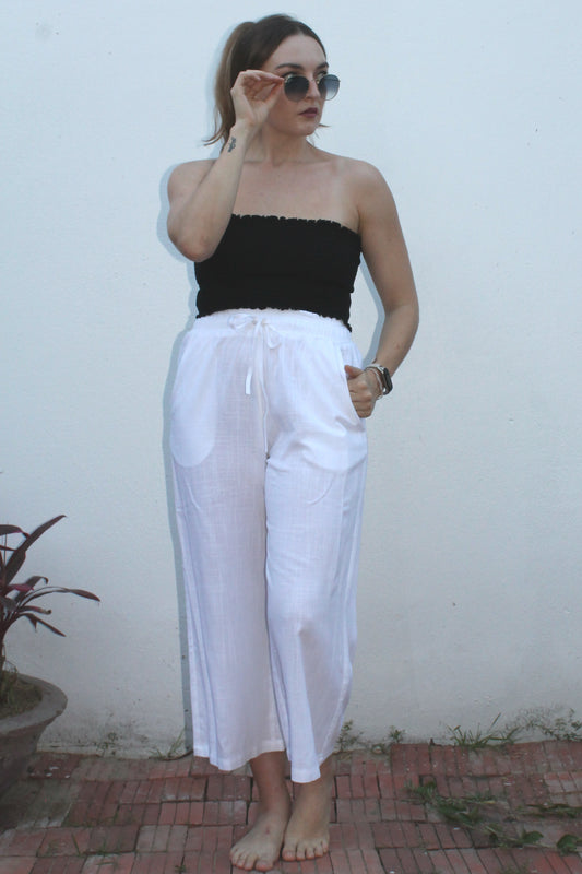 A black top and white pants. 