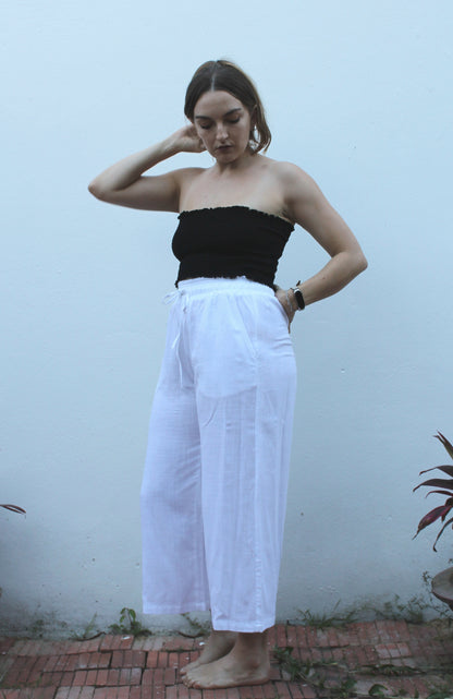 A black top and white pants. 