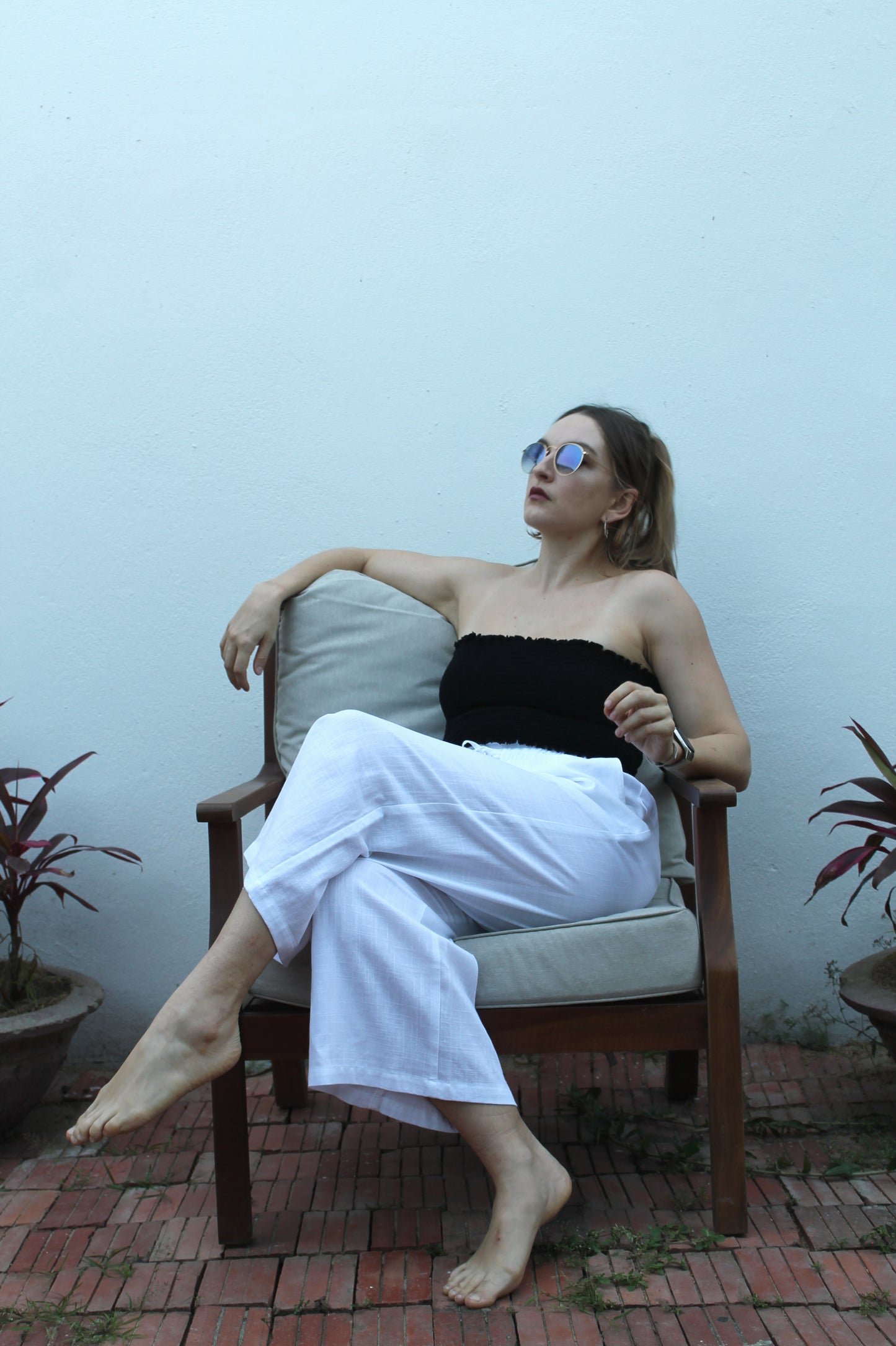A black top and white pants. 