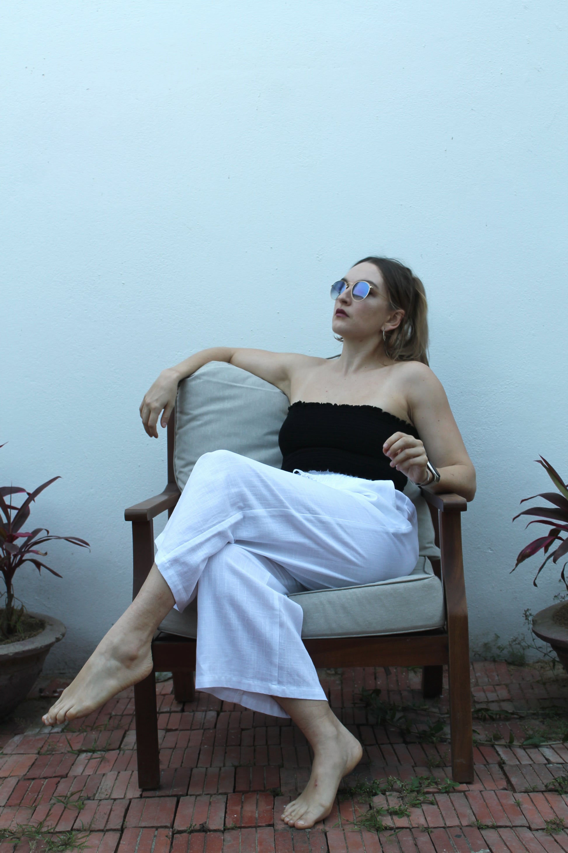 A black top and white pants. 